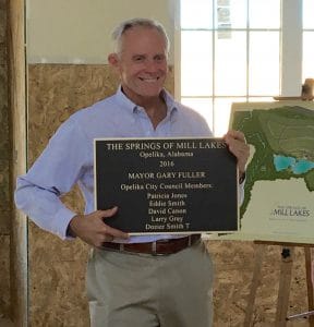 Developer Allen Harris presents plaque to City of Opelika officials.